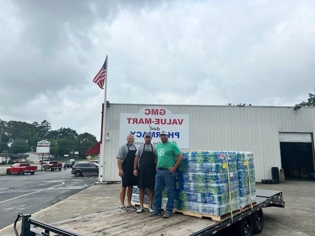 Rome, Ga. IP employees load water on a flatbed trailer